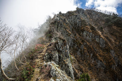 Low angle view of rocks against sky