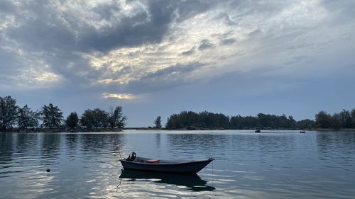 Boat in lake against sky