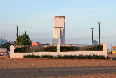 Buildings in city against clear sky