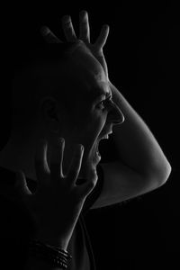 Close-up of human hand against black background