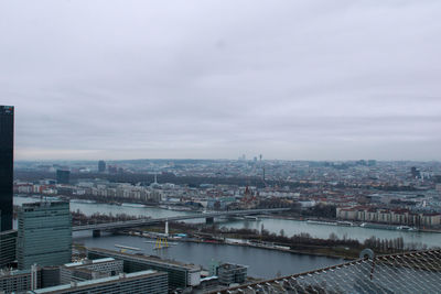 High angle view of river amidst buildings in city against sky
