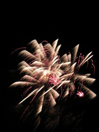 Firework display against sky at night