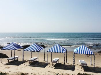 Scenic view of beach against blue sky