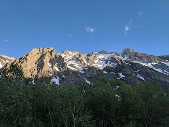 Scenic view of mountains against blue sky