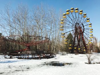 Low angle view of ferris wheel against clear sky