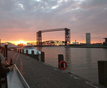 Pier over river with city in background