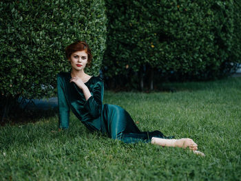 Portrait of woman sitting on field