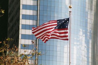 Low angle view of flag against clear sky