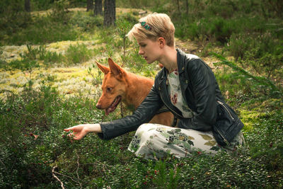 Young woman with dedicated dog in park scenic photography