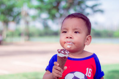 Portrait of cute boy against ice cream