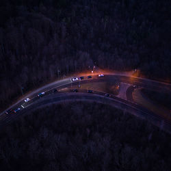 Aerial view of road through forest at night