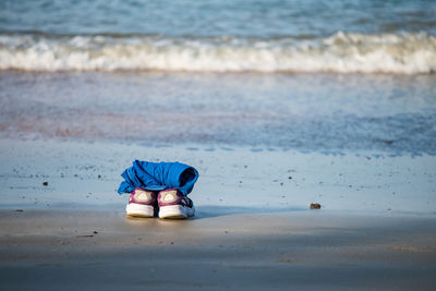 Shoes and shirt at beach. holiday summer background