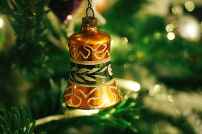 Close-up of decoration hanging on illuminated christmas tree
