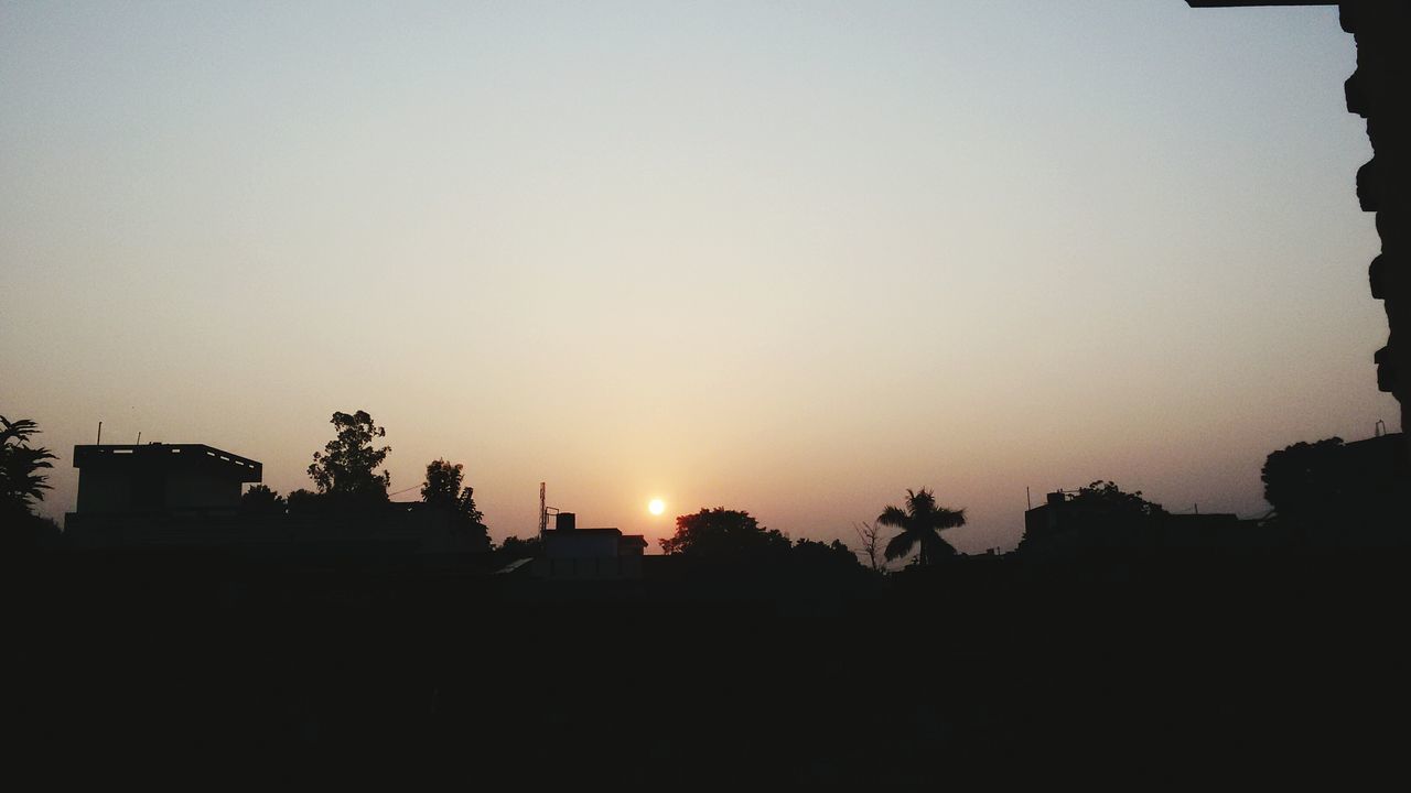 sunset, silhouette, building exterior, architecture, built structure, copy space, sun, clear sky, tree, house, low angle view, sky, orange color, sunlight, residential structure, building, nature, outline, outdoors, dark