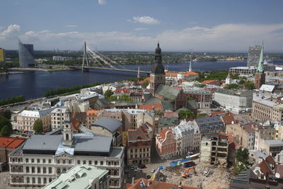 Vansu bridge over daugava river in city against sky