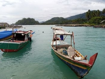 Boat moored in sea against sky