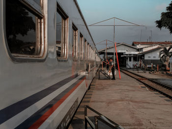 Train at railroad station platform against sky