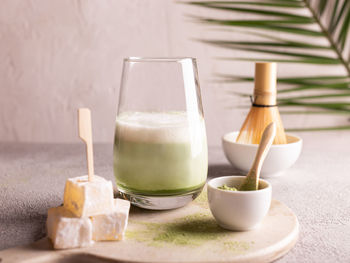 Green tea matcha latte on a white stone board