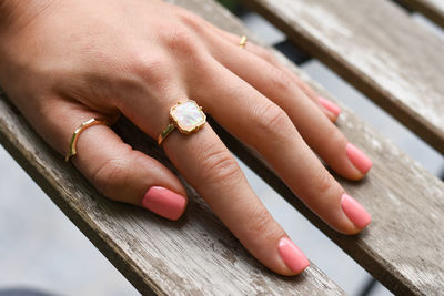 Cropped hand of woman wearing ring on table