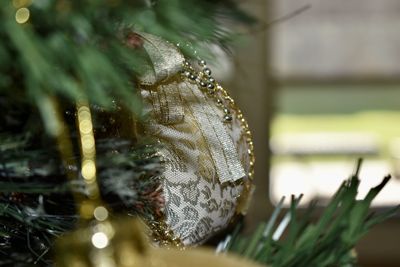 Golden christmas ornament on tree during day