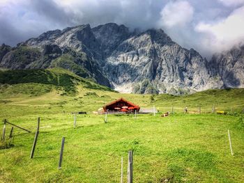 Tractor on field against mountain range