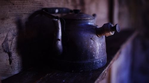 Close-up of old-fashioned tea kettle in darkroom