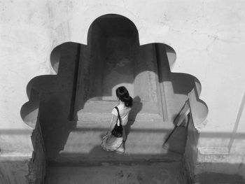 Woman standing against wall