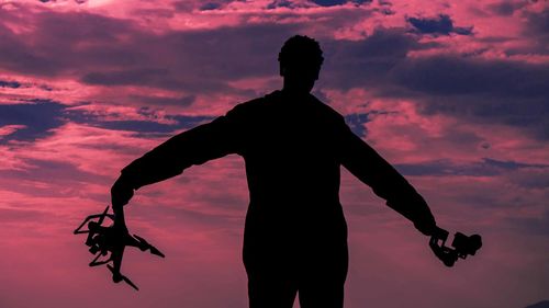 Low angle view of silhouette man against sky during sunset