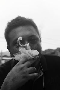 Portrait of man smoking cigarette