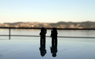 Close-up of silhouette camera against clear sky
