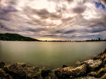 View of calm lake against cloudy sky