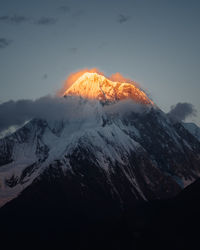 Scenic view of snowcapped mountains against sky during sunset