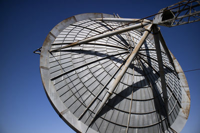 Low angle view of metallic structure against clear blue sky