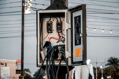 Low angle view of telephone pole against building