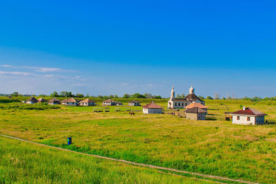 Houses on field against sky