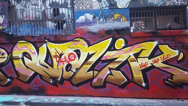 graffiti, art, multi colored, text, art and craft, built structure, creativity, architecture, western script, building exterior, wall - building feature, yellow, street art, communication, mural, vandalism, human representation, wall, no people, outdoors