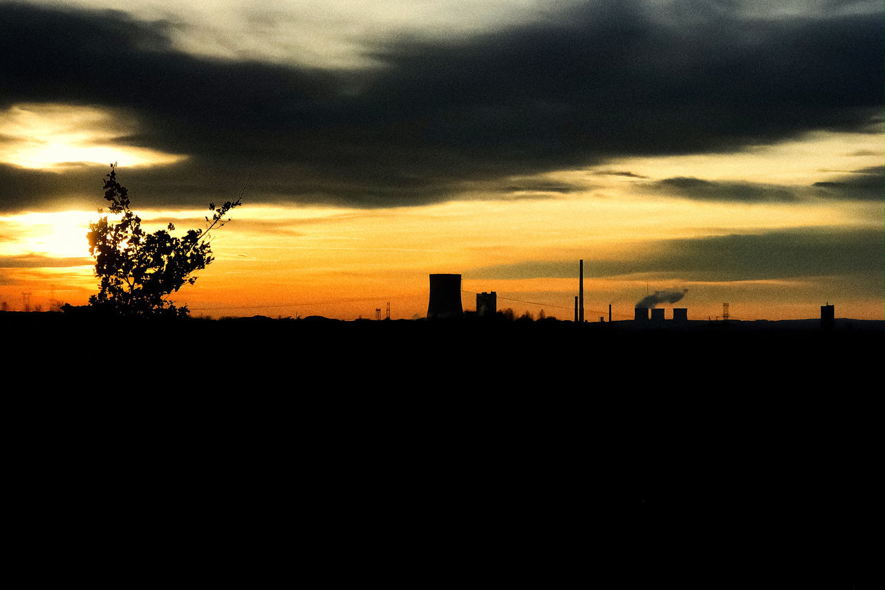 SILHOUETTE OF FACTORY AT SUNSET