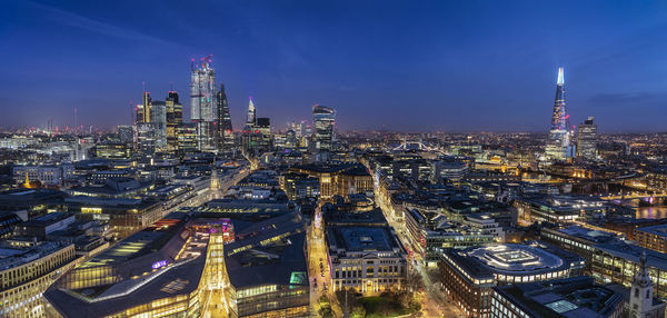 High angle view of city lit up at night