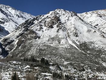 Scenic view of snowcapped mountains against clear sky