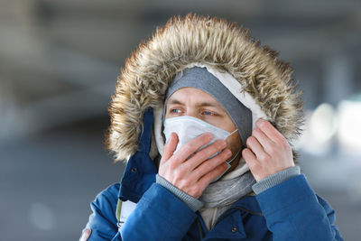 Close-up of man wearing mask coughing