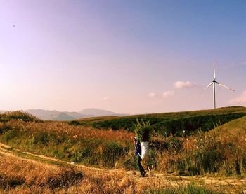 Low angle view of traditional windmill on field