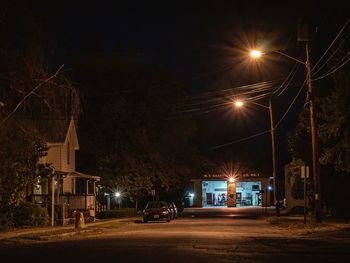 Cars parked on road at night