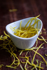 Close-up of shattered lemon in bowl on table