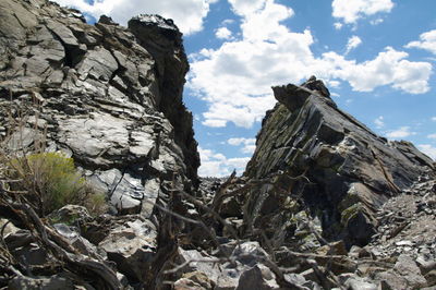 Low angle view of rock against sky