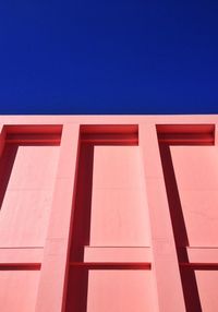 Low angle view of built structure against clear blue sky