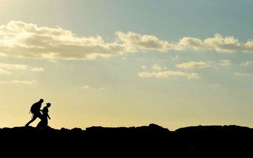 Silhouette of man against sky at sunset
