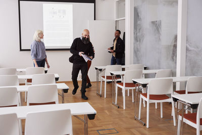 People entering meeting room