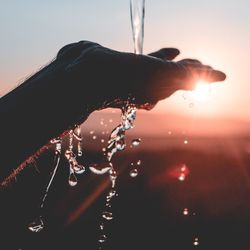 Close-up of water against sky at sunset