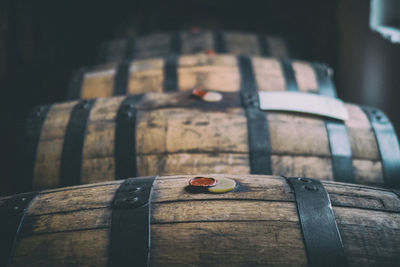 Whisky in wooden barrels with tax seals aging near a window