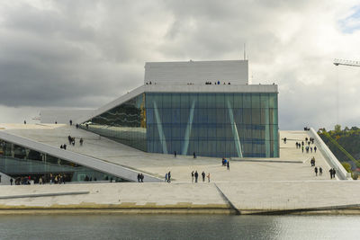 Group of people in building against sky